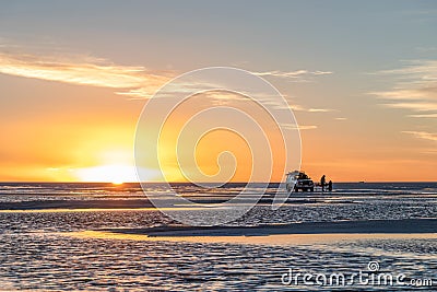 Happy tourists enjoy Sunset during four wheel tour in Salt flat Lake Salar de Uyuni in Bolivia Editorial Stock Photo